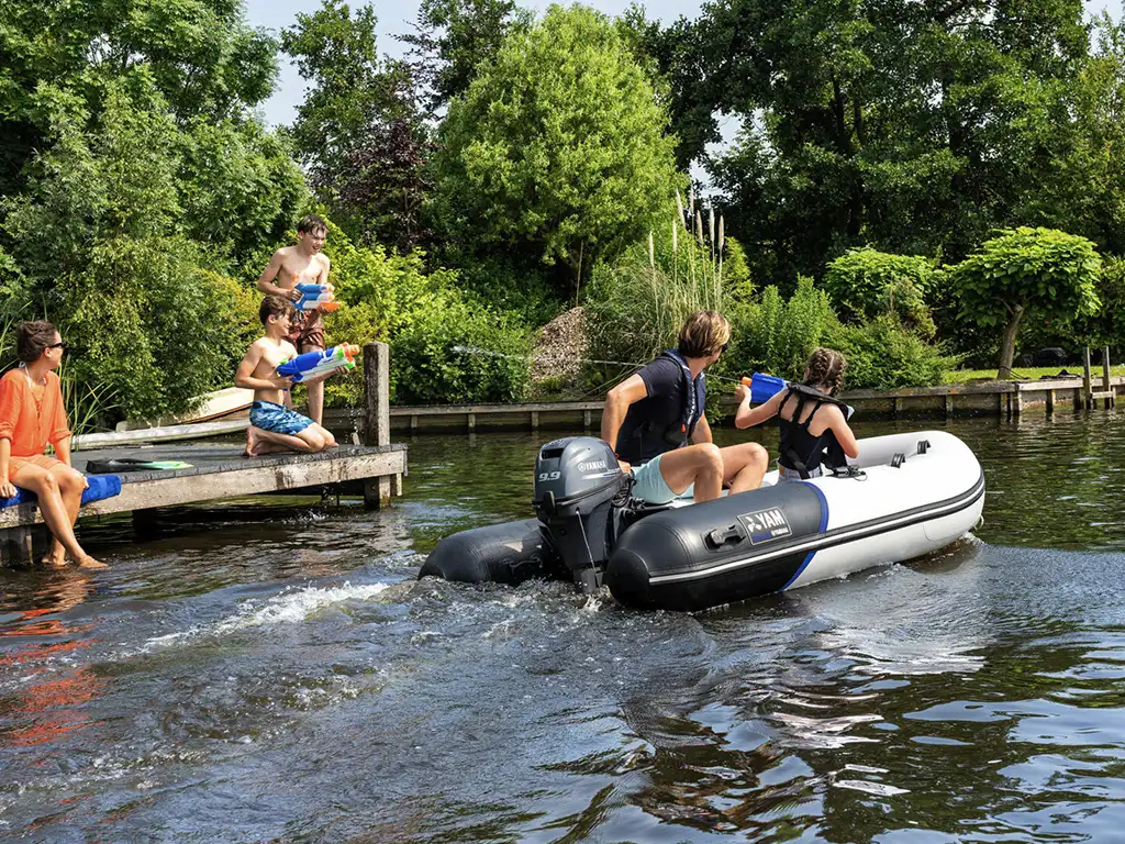 Two people on a Yamaha inflatable with Yamaha Outboard on the water.